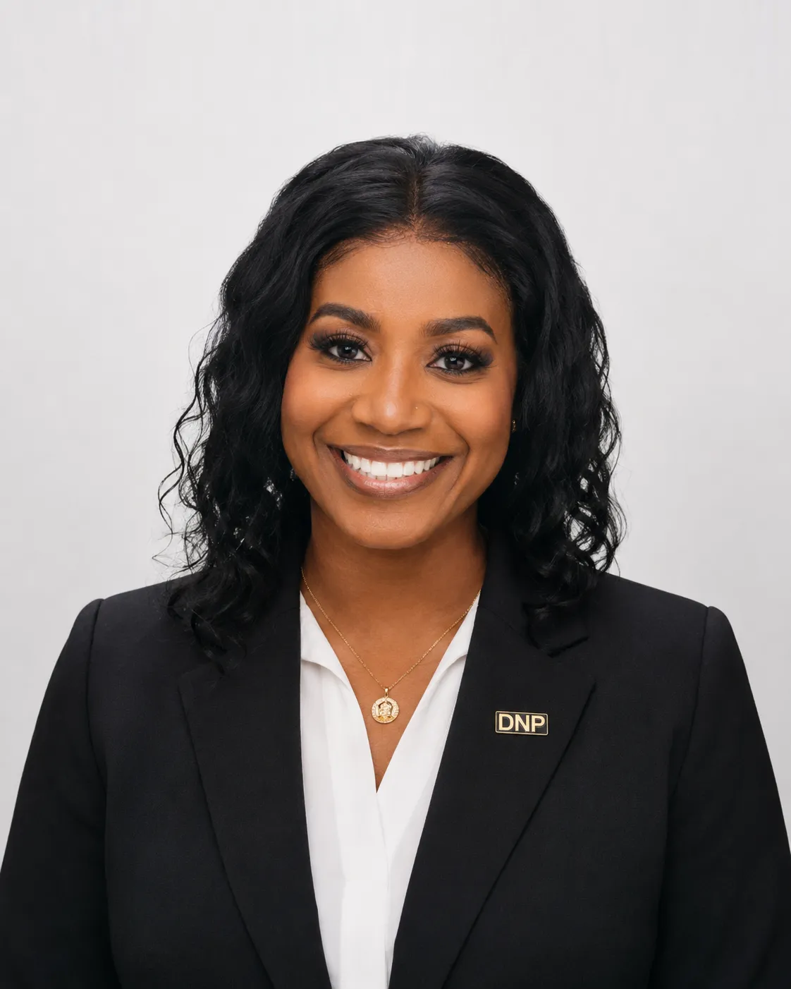 Dr. Jennifer Asante, smiling, in a dark blazer with a DNP pin.